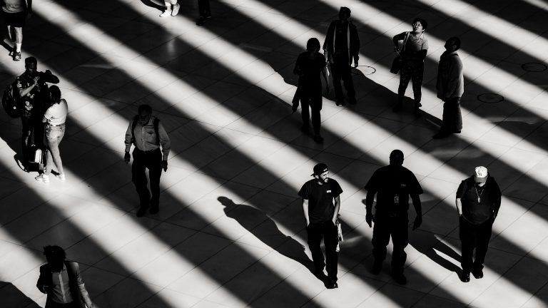 People walking across floor, creating shadows.